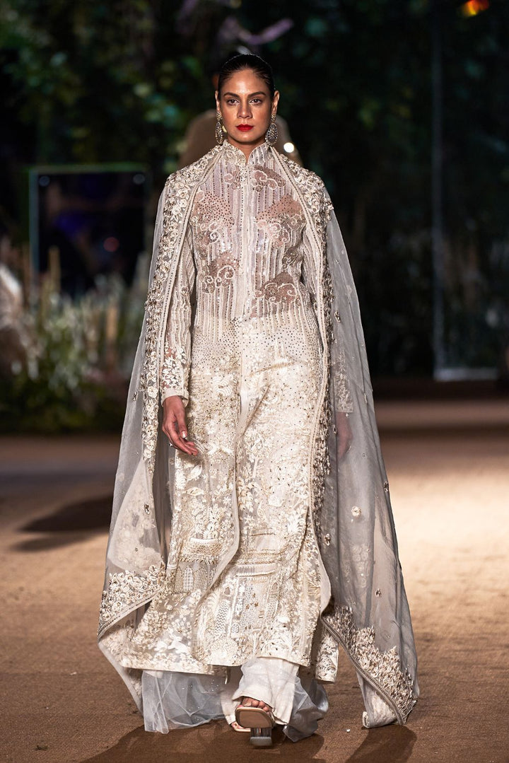 Navbhumi Silk Organza Kurta with Sequinence Hand-Sequinned Trousers and Rainbow Dupatta in Ivory, Gold, and Nude